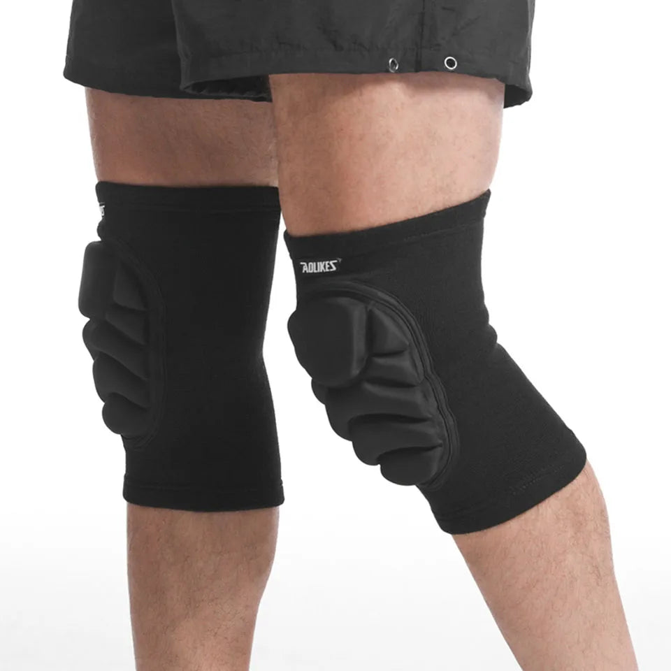 Black sports knee pads for joint support with padded protection worn on both knees