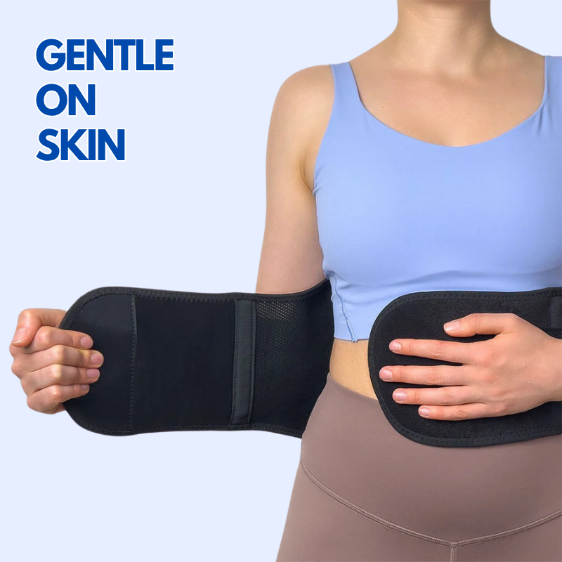 Woman wearing a black lumbar back brace for pain relief with adjustable straps gentle on skin