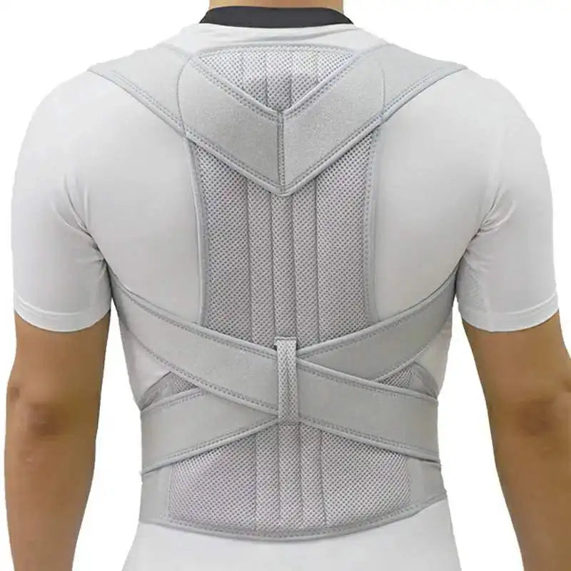 Back view of adjustable scoliosis posture corrector in gray worn over white shirt by male model
