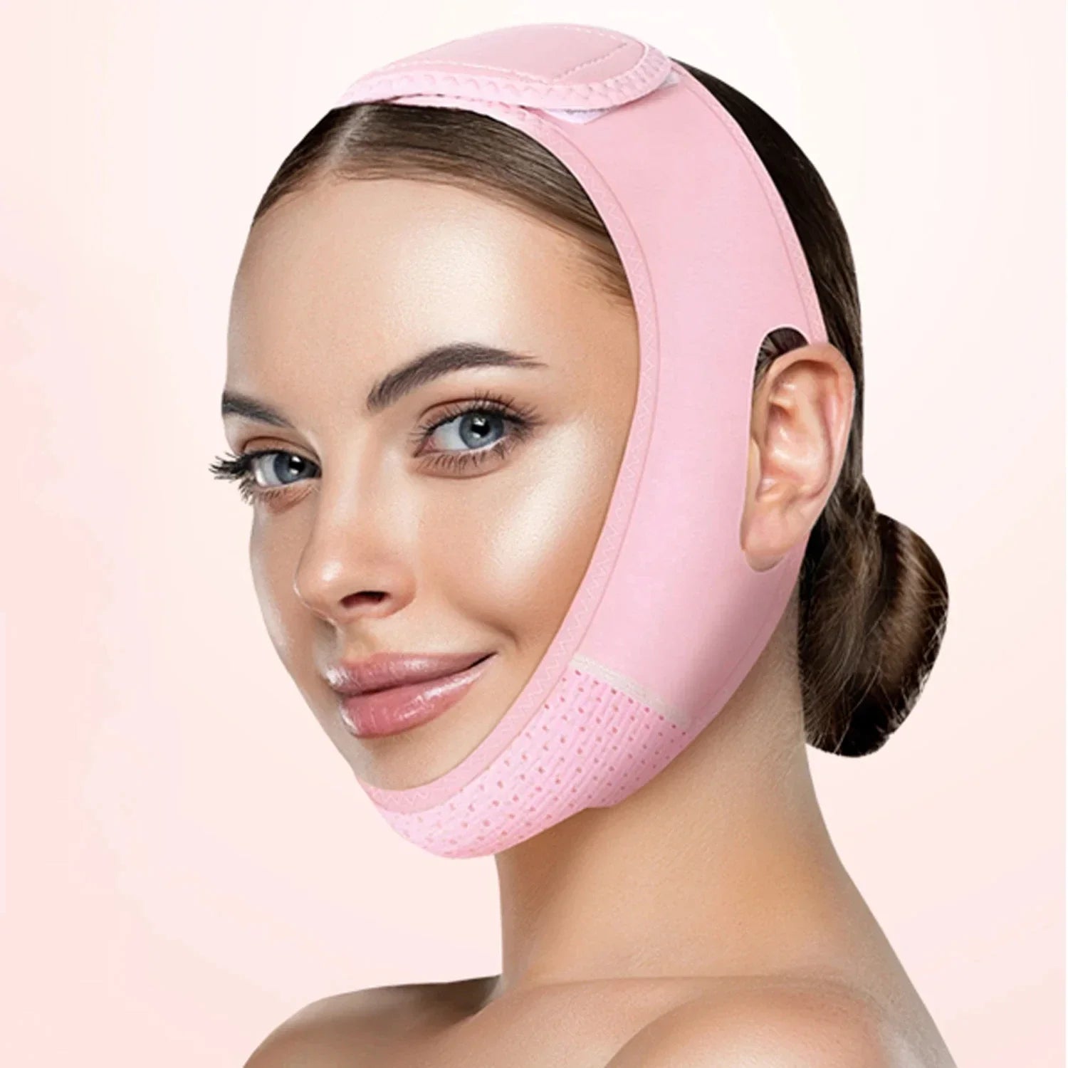 Woman wearing a pink face slimming band for women by Zorelie co to contour and lift the jawline