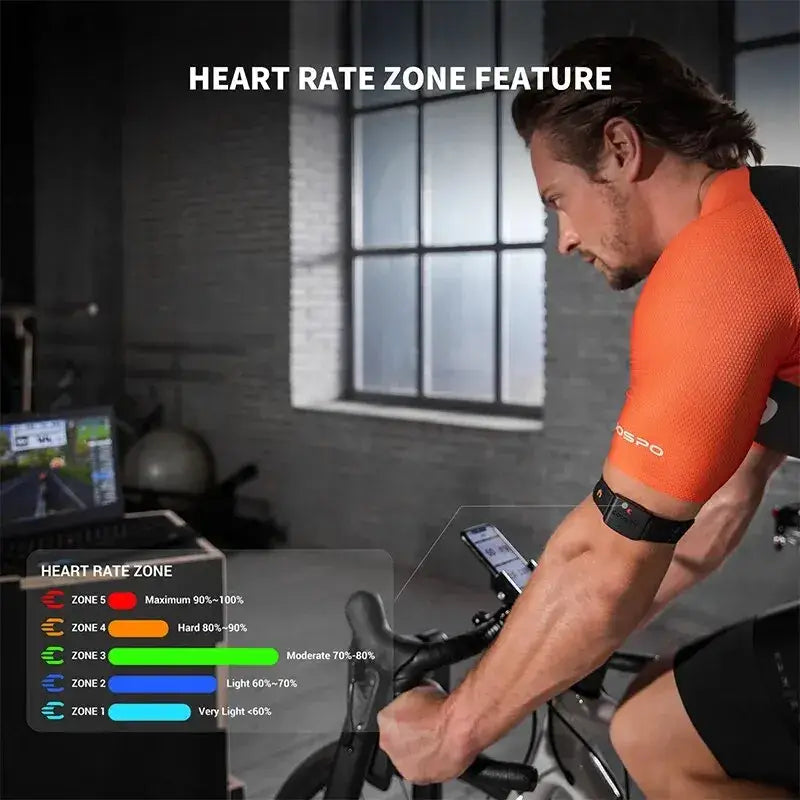 Man wearing orange sleeve and armband heart rate monitor BLE5.0 while cycling indoors monitoring heart rate zones
