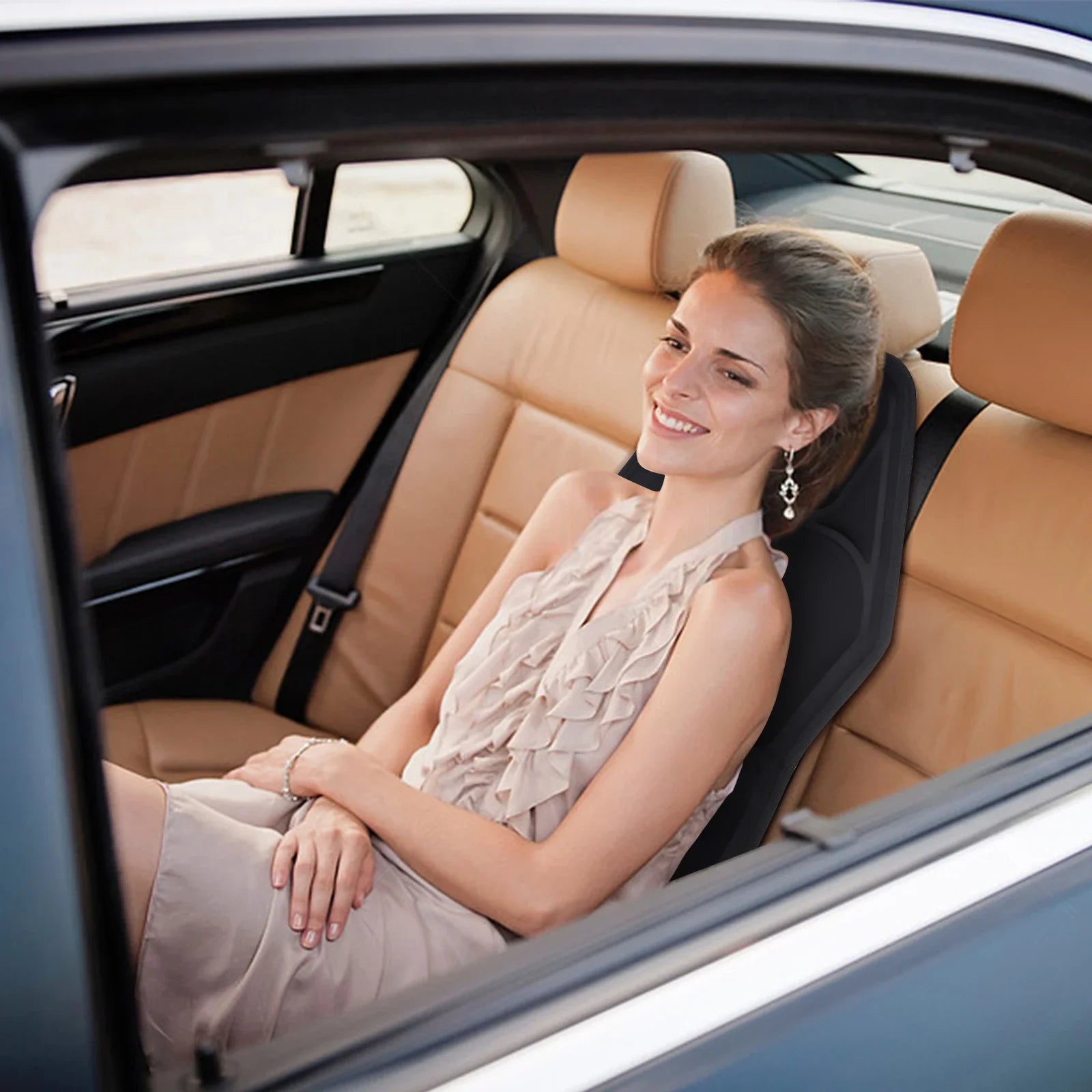 Woman relaxing on electric back massager cushion in car seat for comfort and relief