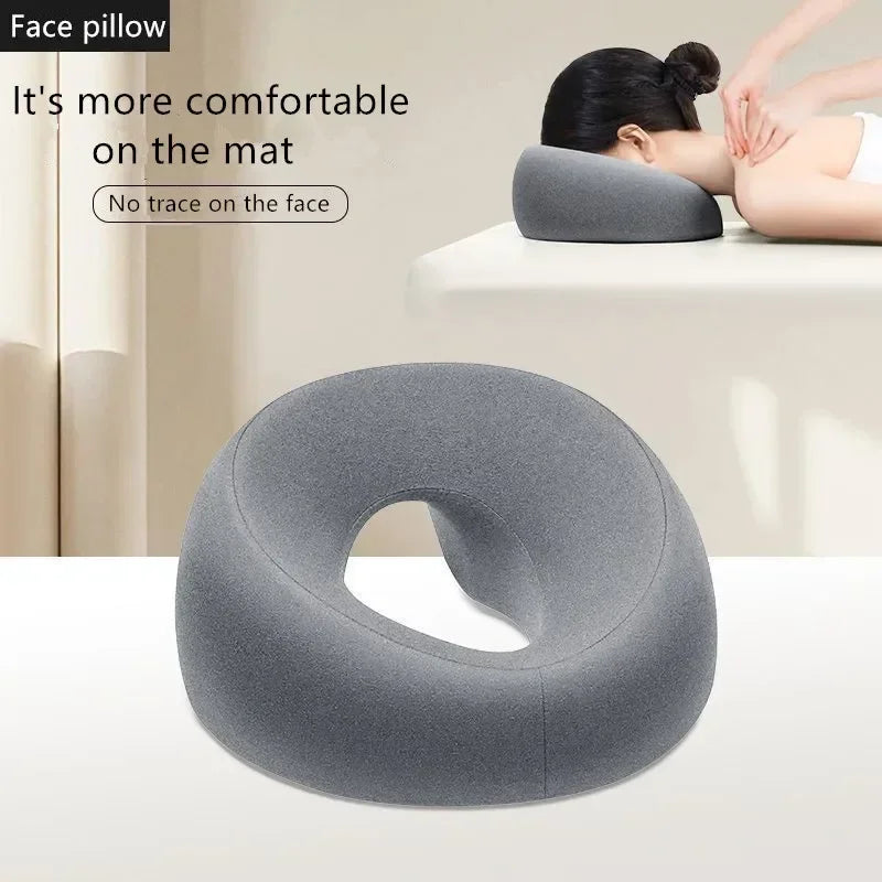 Ergonomic memory foam headrest in gray designed for comfortable face support during massages