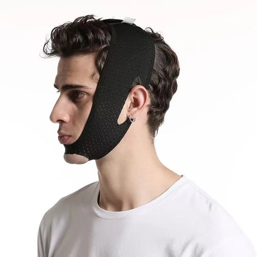 Side view of man wearing black adjustable face lift massager device for chin and jaw support