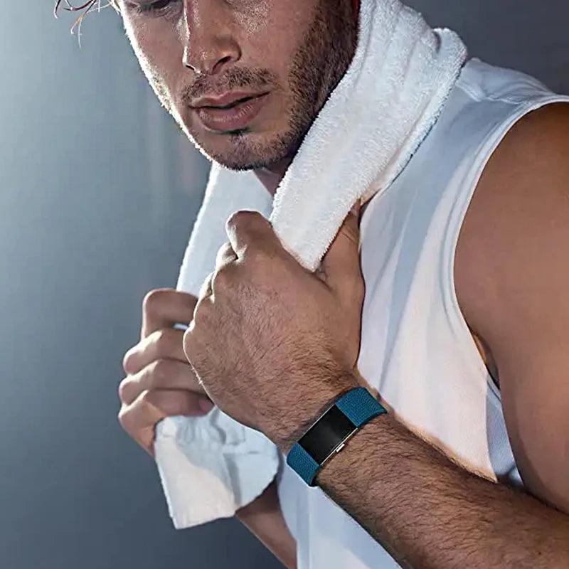Man wearing a blue smart fitness wristband with sleep monitor during workout with white towel