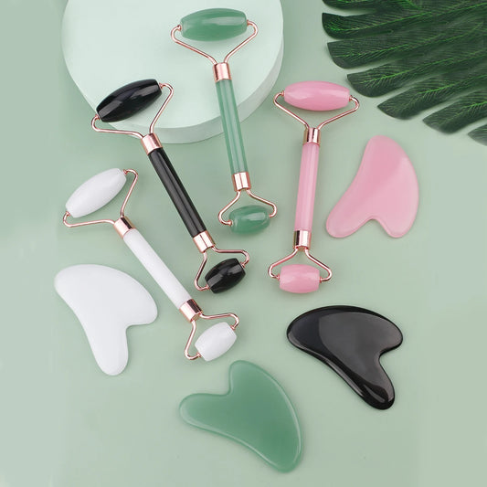 Set of colorful gua sha facial massage roller tools with matching scrapers for skincare