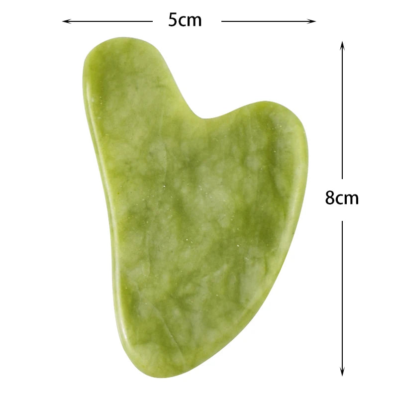 Green natural stone gua sha facial tool with smooth polished surface and heart-shaped edges