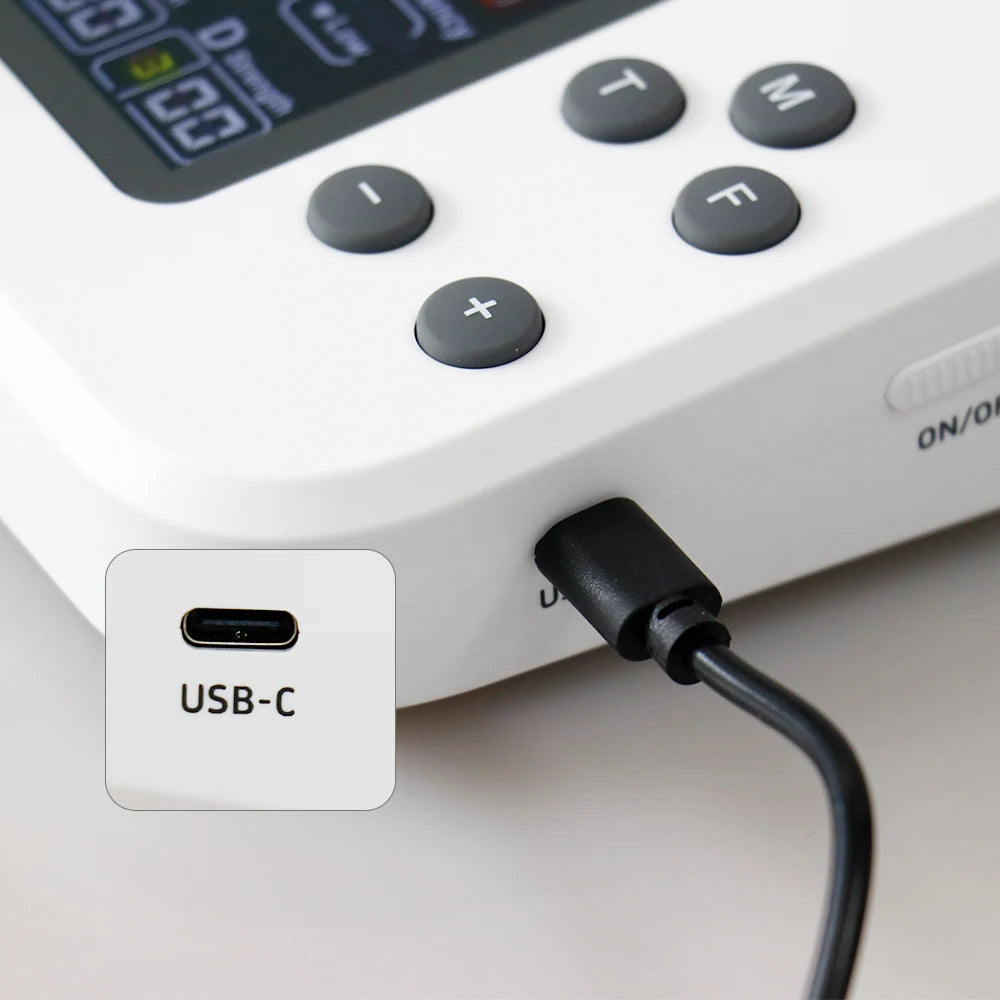 Close-up of Zorelie.co TENS EMS physiotherapy machine showing control buttons and USB-C charging port