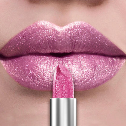 Close-up of lips wearing glitter metallic lipstick in shimmering pink shade with applied lipstick tube