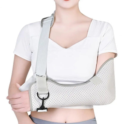 Adjustable kids arm sling in light gray worn by person in white shirt for arm support and comfort