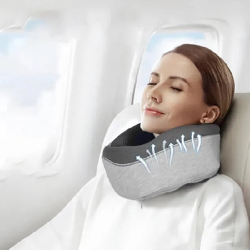 Woman resting on airplane seat using gray memory foam travel neck pillow for comfort