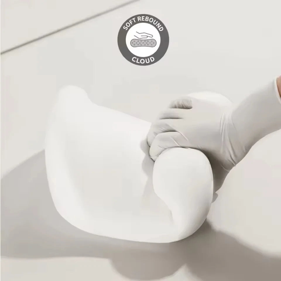 Soft white car seat neck pillow and lumbar support being squeezed to show cloud-like rebound softness