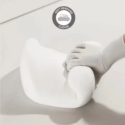 Soft white car seat neck pillow and lumbar support being squeezed to show cloud-like rebound softness