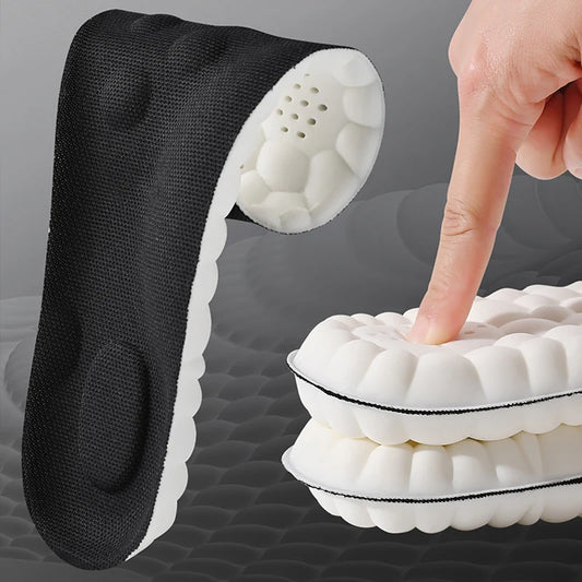 Orthotic arch support insoles with cushioned white foam and black fabric top cover showing flexibility and comfort