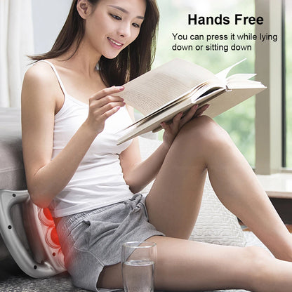 Woman using Zorelie.co hands free deep tissue massage gun on lower back while reading a book