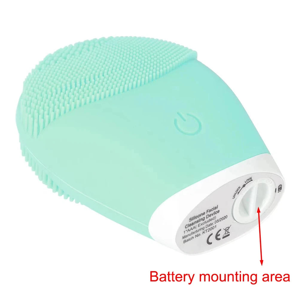 Mint green silicone facial cleansing brush with soft bristles and battery mounting area