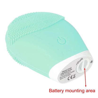 Mint green silicone facial cleansing brush with soft bristles and battery mounting area