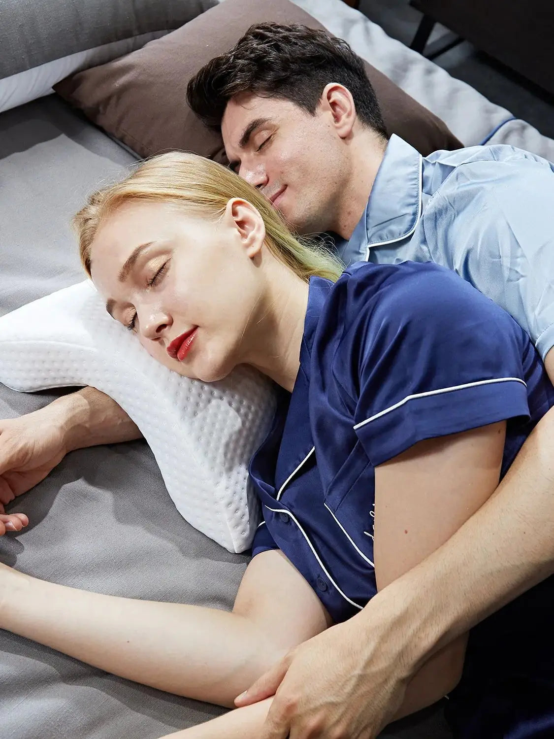 Couple sleeping comfortably on a slow rebound memory foam pillow by Zorelie.co for better support and rest