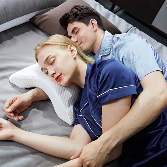 Couple sleeping comfortably on bed using slow rebound memory foam pillow by Zorelie.co