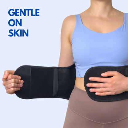 Woman wearing a black lumbar back brace for pain relief with adjustable straps gentle on skin