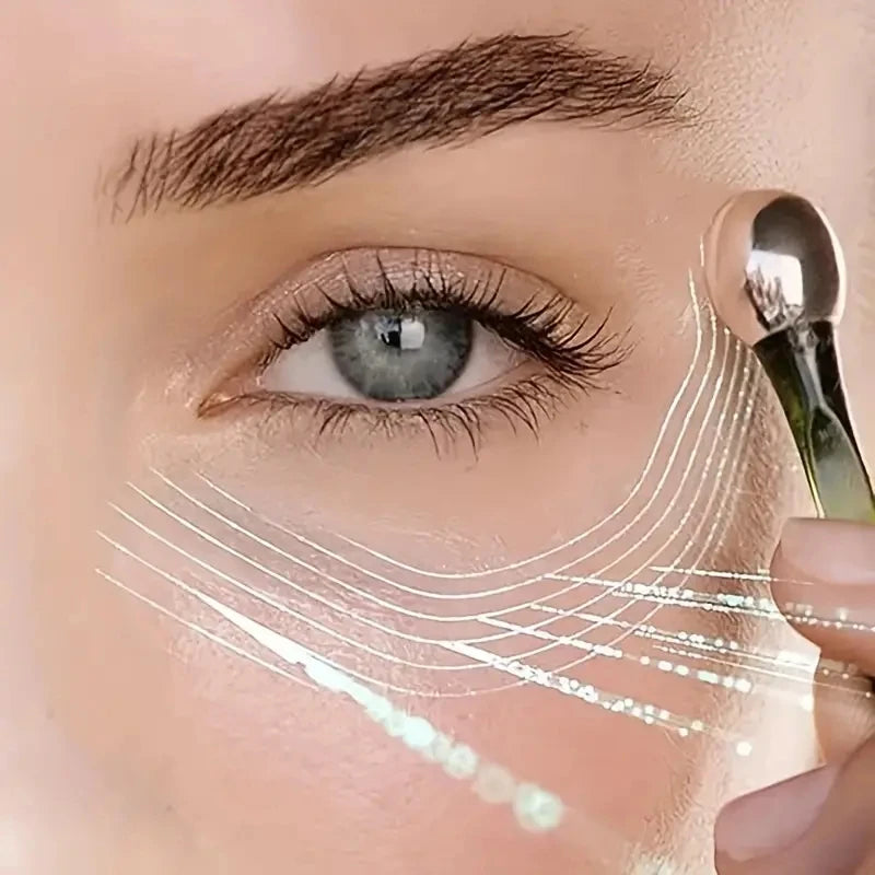 Close-up of a woman using a Zorelie.co under eye roller massage stick on her skin
