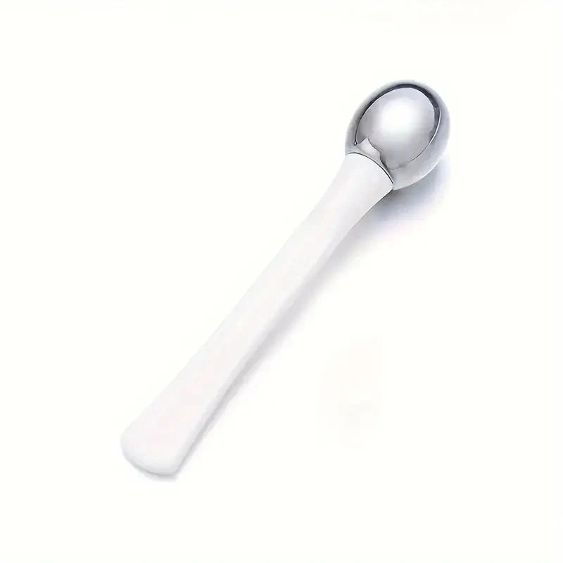 White and silver under eye roller massage stick for gentle facial massage and puffiness relief
