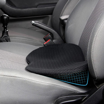 Black memory foam car seat cushion placed on gray car seat for enhanced comfort and support